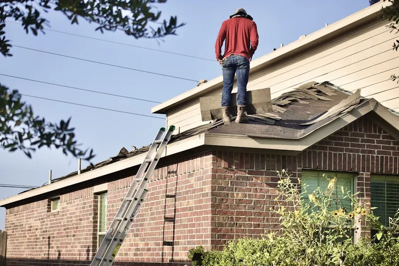 Professional roofer working on a residential roof in Edison